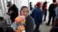 Maria Rafaela Blancante, of the Mexican state of Michoacan, holds her daughter, Jazmin, as they wait with other families to request political asylum in the United States, across the border in Tijuana, Mexico.