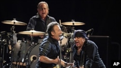 Bruce Springsteen performs with Steven Van Zandt and the E-street band April 17, 2012, in Cleveland. Max Weinberg plays the drums.