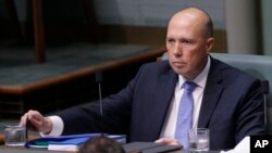 Menteri dalam negeri Peter Dutton berbicara di depan parlemen di Canberra, Australia.