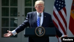 FILE - U.S. President Donald Trump gestures as he speaks during a news conference in the Rose Garden at the White House in Washington, Sept. 26, 2017.