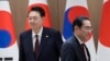 FILE - South Korea's President Yoon Suk Yeol, left, and Japan's Prime Minister Fumio Kishida move their positions during a meeting at the Presidential Office in Seoul on May 26, 2024.