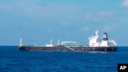 In this undated photo released by the Indonesian Navy on Wednesday, Aug. 25, 2021, the Bahamas-flagged tanker MT Strovolos is seen in the waters off Riau Islands, Indonesia. (Indonesian Navy via AP)