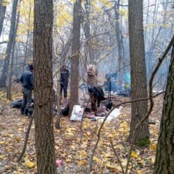 FILE - Migrants are pictured at their camp in an image taken by a migrant who declared that they were located on the Belarusian side of border with Poland in this Oct. 27, 2021, photo, provided by a relative of migrants in Poland.