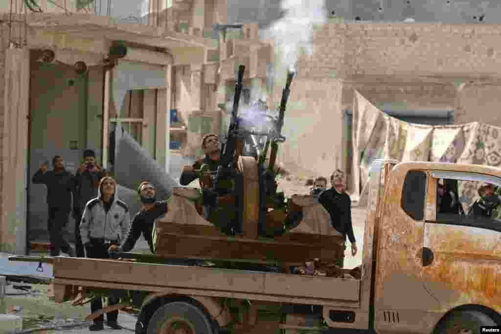 Free Syrian Army fighters fire an anti-aircraft weapon towards forces loyal to Syria's President Bashar al-Assad in the Handarat area, north of Aleppo.