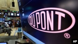 The company name of Dupont appears above its trading post on the floor of the New York Stock Exchange, Dec. 9, 2015.