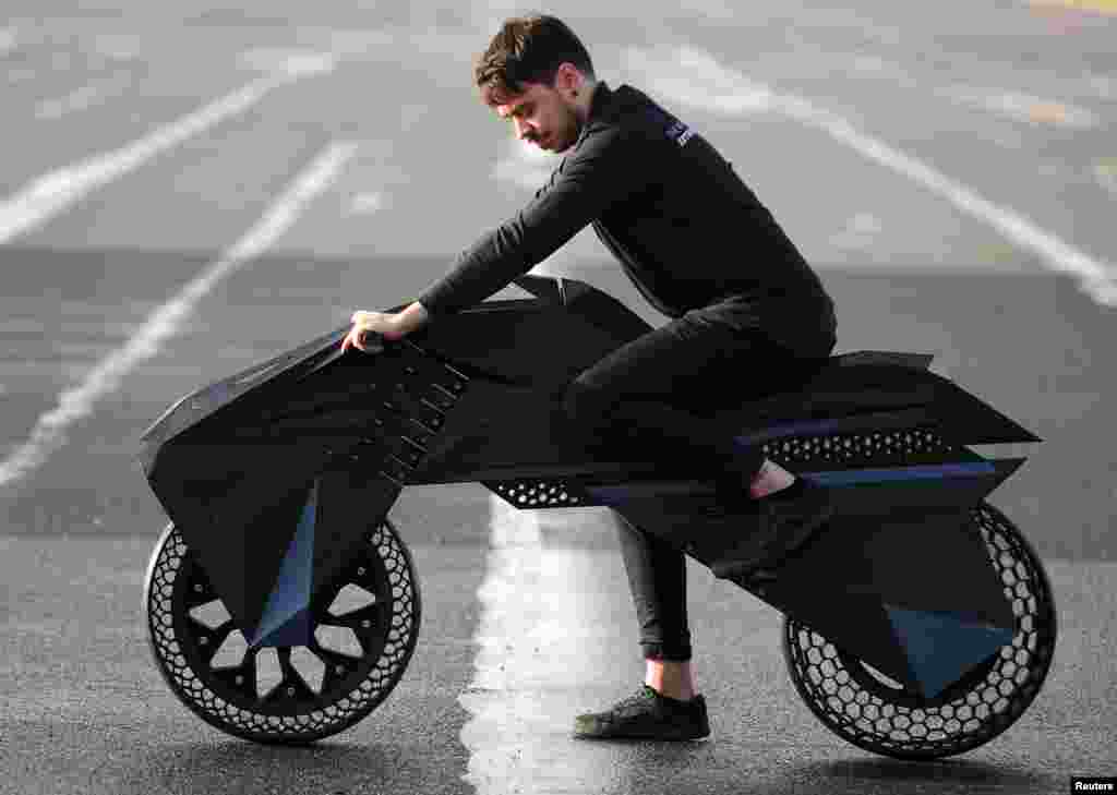 Designer Marco Mattia Cristofori of the German 3D printer manufacturer BigRep, stands with his nearly completely 3D printed e-motorcycle NERA, at the airfield Tempelhof in Berlin.