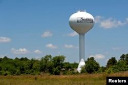 A water tower with the town slogan "ham, history and hospitality" rises over Smithfield, Virginia, May 30, 2013.