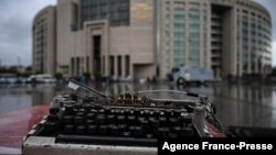 FILE - A broken typewriter is symbolicaLly displayed outside Istanbul's courthouse during a retrial of a journalist and press freedom activist on charges of supporting Kurdish militants, in Istanbul, Turkey, Sept. 30, 2021.