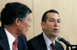 FILE - CIT Group Chairman and CEO John Thain, left, and OneWest President and CEO Joseph Otting participate in a public meeting at the Los Angeles branch of the Federal Reserve Bank of San Francisco, Feb. 26, 2015.