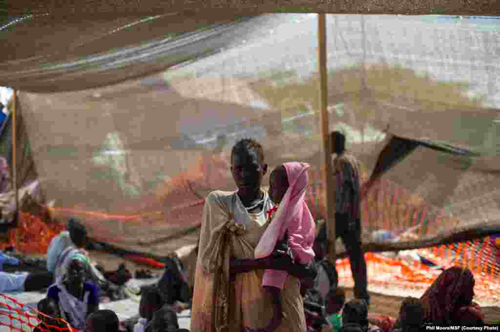 A woman stands with her daughter in the Médecins Sans Frontières (MSF) clinic set up at the camp for displaced people in the grounds of the United Nations Mission to South Sudan (UNMISS) base in Juba.