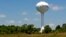 A water tower with the town slogan "ham, history and hospitality" rises over Smithfield, Virginia, May 30, 2013. 