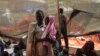 A woman stands with her daughter in the Médecins Sans Frontières (MSF) clinic at the camp for displaced people on the grounds of the United Nations Mission to South Sudan base in Juba, South Sudan, on January 12, 2014.