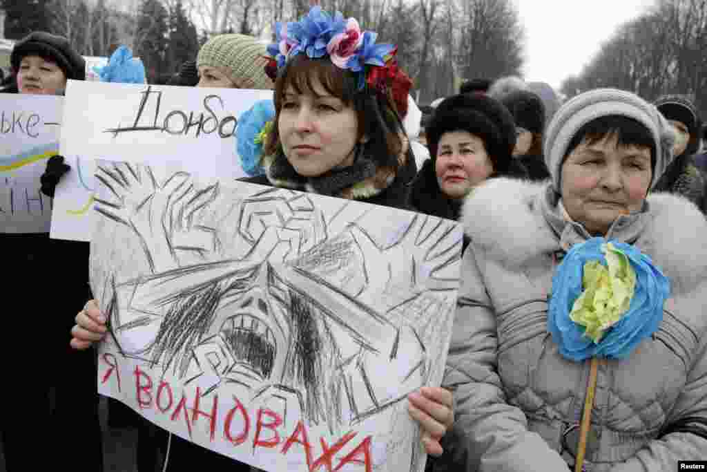 Women take part in a peace march to honor victims of an attack in eastern Ukraine where Ukrainian authorities said fighting intensified around the Donetsk airport as separatists tried to oust government forces, near the town of Volnovakha, Ukraine, Jan. 18, 2015.