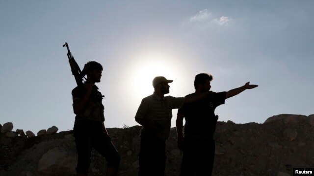 Armed Free Syrian Army fighters near Wadi Al-Dayf camp in the southern Idlib countryside, Sept. 14, 2014. 
