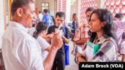 Teachers in trainings at the National University of East Timor practice an interactive English game.