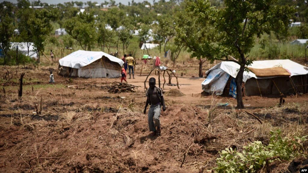 FILE - A young South Sudanese refugee walks in the Pagirinya refugee settlement in Adjumani, north of Kampala, Uganda, Aug. 29, 2016.