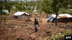 FILE - A young South Sudanese refugee walks in the Pagirinya refugee settlement in Adjumani, north of Kampala, Uganda, Aug. 29, 2016.