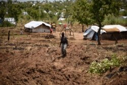 FILE - A young South Sudanese refugee walks in the Pagirinya refugee settlement in Adjumani, north of Kampala, Uganda, Aug. 29, 2016.