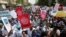 Striking doctors hold placards and chant slogans outside the Court of Appeal as they wait for the release of jailed officials of the national doctors' union in their case to demand fulfillment of a 2013 agreement between their union and the government that that would raise their pay and improve working conditions in Nairobi, Kenya, Feb.15, 2017.