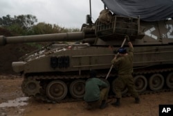 FILE - Israeli soldiers fix tracks near the border with Lebanon, in northern Israel, January 11, 2024.