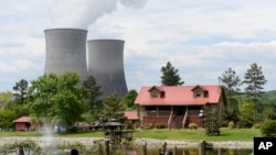 FILE - The Watts Bar Nuclear Plant cooling towers Unit 1, left, and Unit 2 rise near Spring City, Tenn., April 29, 2015. Construction of Unit 2 was started, abandoned, then restarted, becoming a cautionary tale for the power industry. 
