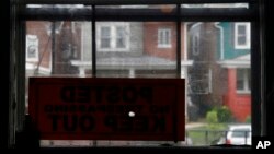 FILE - A bullet hole pierces a "no trespassing" sign at the home of William Rollins V and his wife, Maria WIlliams, in Wilmington, Del., the day after the home came under gunfire, July 27, 2017.