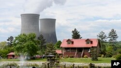 The Watts Bar Nuclear Plant cooling towers Unit 1, left, and Unit 2 rise near Spring City, Tenn., April 29, 2015. Construction of Unit 2 was started, abandoned, then restarted, becoming a cautionary tale for the power industry. 