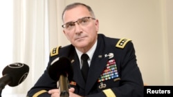 FILE - Commander of the U.S. European Command Curtis M. Scaparrotti speaks during his presentation for Finnish National Defense Course Association in Helsinki, Finland, Aug. 9, 2017. 