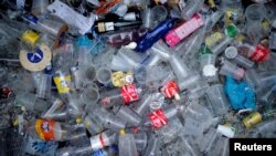 Plastic and glass waste lies on the ground during the Tamborrada on the Day of San Sebastian in the Basque coastal town of San Sebastian, Spain, Jan. 20, 2018. 