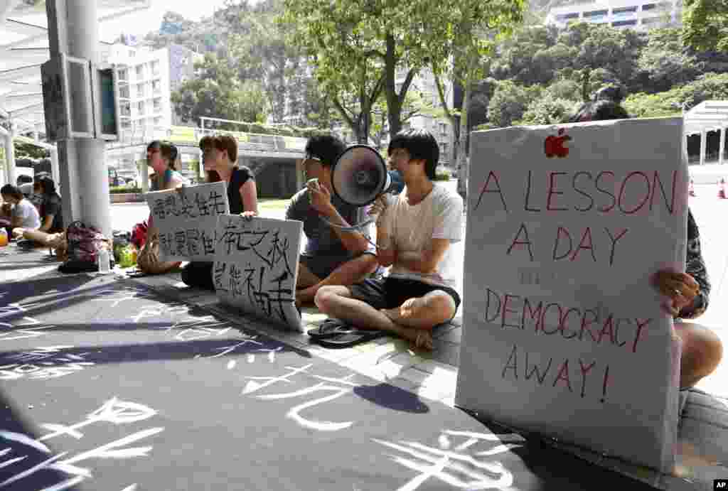 Pro-democracy student protesters show their placards at the Chinese University of Hong Kong campus in Hong Kong, urging students to stop studying, Oct. 6, 2014.