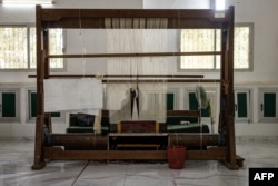 FILE—An artist weaves a prayer mat at the Manufacture Senegalese des Arts in Thies on April 22, 2024.