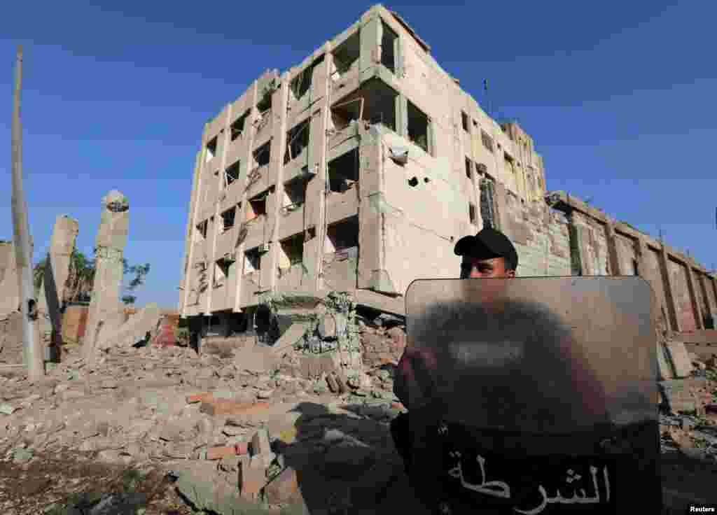 A security official guards the site of a bomb blast at a state security building in Shubra Al-Khaima, on the outskirts of Cairo, Aug. 20, 2015.