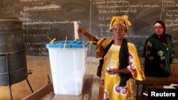 FILE - A woman votes during local elections in Bamako, Mali, Nov. 20, 2016. Mali has delayed regional elections set for December 17, 2017, until April 2018.