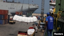 FILE - Humanitarian aid donated by World Food Program is unloaded at Beirut's port, in Beirut, Lebanon, Sept. 3, 2020. 