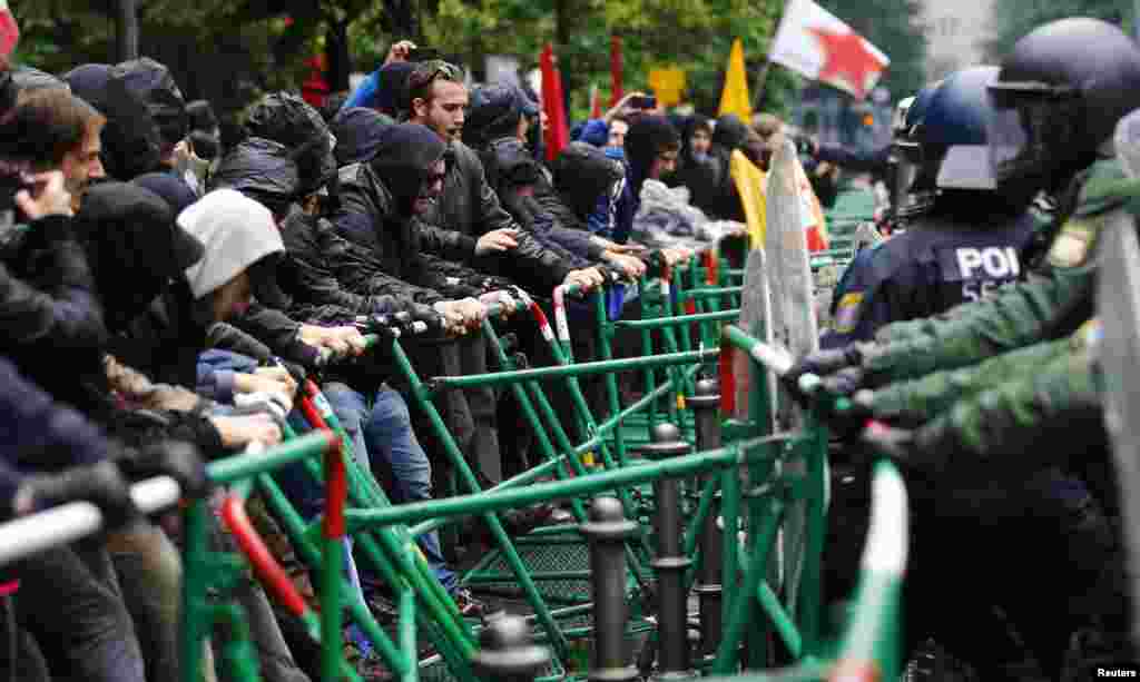 Polisi anti huru hara berusaha mencegah pengunjuk rasa menerobos barikade di markas besar Bank Sentral Eropa dalam demonstrasi anti kapitalis &#39;Blockupy&#39; di Frankfurt. Ribuan demonstran memprotes penanganan krisis utang Eropa.