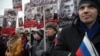 People carry portraits of opposition leader Boris Nemtsov, who was gunned down on Friday near the Kremlin, with words reading "He fought for a free of Russia, He fought for our future!" in Moscow, Russia, March 1, 2015. 