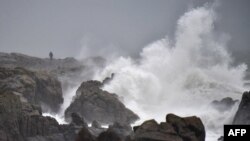 A man looks at heavy waves, on Dec. 31, 2017 in Batz-sur-Mer, western France, a day before storm Carmen is to hit the west of France. 