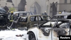 Petugas berusaha memadamkan kebakaran pasca ledakan bom di masjid di kota Dammam, Saudi Arabia, Jumat (29/5).