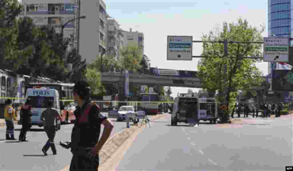 Security members, medics and forensic experts work at the scene after a bomb exploded at a bus stop during rush hour in Istanbul, Turkey, Thursday, May 26, 2011. Seven people were injured as several ambulances rushed to the scene on a multi-lane thoroughf