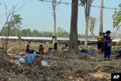 FILE - On April 6, 2023, residents of eastern Myanmar fled from Myawaddy District in Myanmar into Tak Province in Thailand.