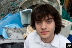 Dutch university dropout Boyan Slat, who founded the The Ocean Cleanup, poses for a portrait next to a pile of plastic garbage prior to a press presentation in Utrecht, Netherlands, May 11, 2017.
