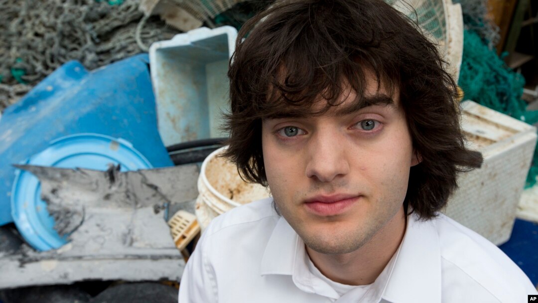 Dutch university dropout Boyan Slat, who founded the The Ocean Cleanup, poses for a portrait next to a pile of plastic garbage prior to a press presentation in Utrecht, Netherlands, May 11, 2017. 