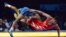 ordan Burroughs of the United States takes down Ezzatollah Akbari Zarinkolaei of Iran during the 2014 FILA Freestyle Wrestling World Cup on March 15, 2014 in Inglewood, California. 
