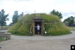 Mikah in a reconstruction of an earthlodge at the Knife River Indian Villages National Historic site, North Dakota.