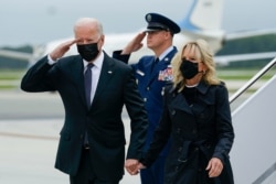 President Joe Biden returns a salute as he and first lady Jill Biden arrive at Dover Air Force Base, Del., Aug. 29, 2021.