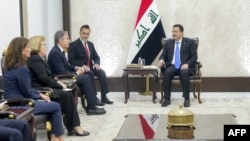 In this photo released by the Iraqi Prime Minister's Media Office, Prime Minister Mohammed Shia al-Sudani, right, meets with U.S. Secretary of State Antony Blinken, third from left, in Baghdad on Dec. 13, 2024.