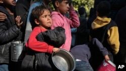 Palestinian children queue for food in Deir al-Balah, Gaza Strip, Dec. 13, 2024. 