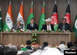 Afghanistan President Ashraf Ghani, 2nd right, Pakistani Prime Minister Shahid Khaqan Abbasi, right, Turkmenistan President Gurbanguly Berdymukhamedov, 2nd left, and India's Minister of State for External Affairs M.J. Akbar, left, attend the inauguration ceremony of TAPI pipeline construction work, in Herat, Afghanistan, Feb. 23, 2018.