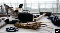 Prohibited items found during screenings at TSA checkpoints are displayed before a news conference on aviation security ahead of the summer travel season at Ronald Reagan Washington National Airport, May 25, 2021, in Arlington, Va.