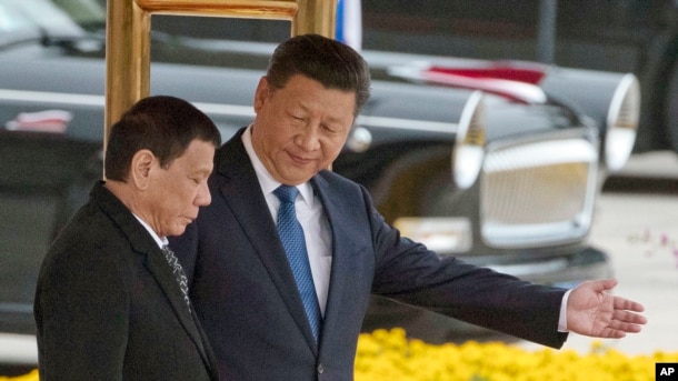 Chinese President Xi Jinping, right, and Philippine President Rodrigo Duterte are seen during a welcome ceremony outside the Great Hall of the People in Beijing, China, Oct. 20, 2016.